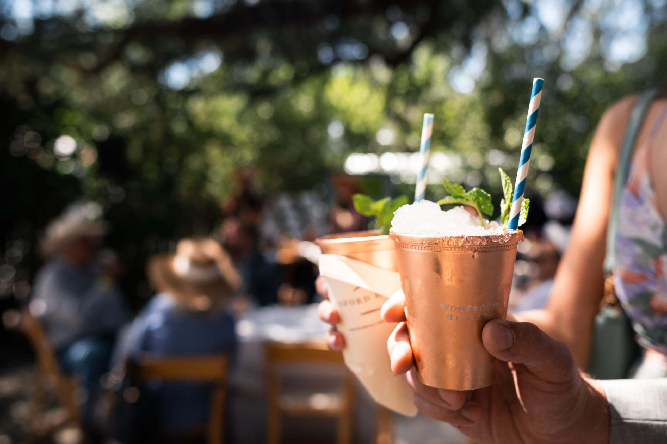 Farmstead_Derby_2022-9897 Person holding a copper glass with a straw and ice
