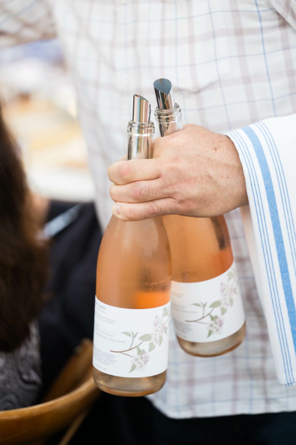 Person holding two bottles of Long Meadow Ranch Rosé